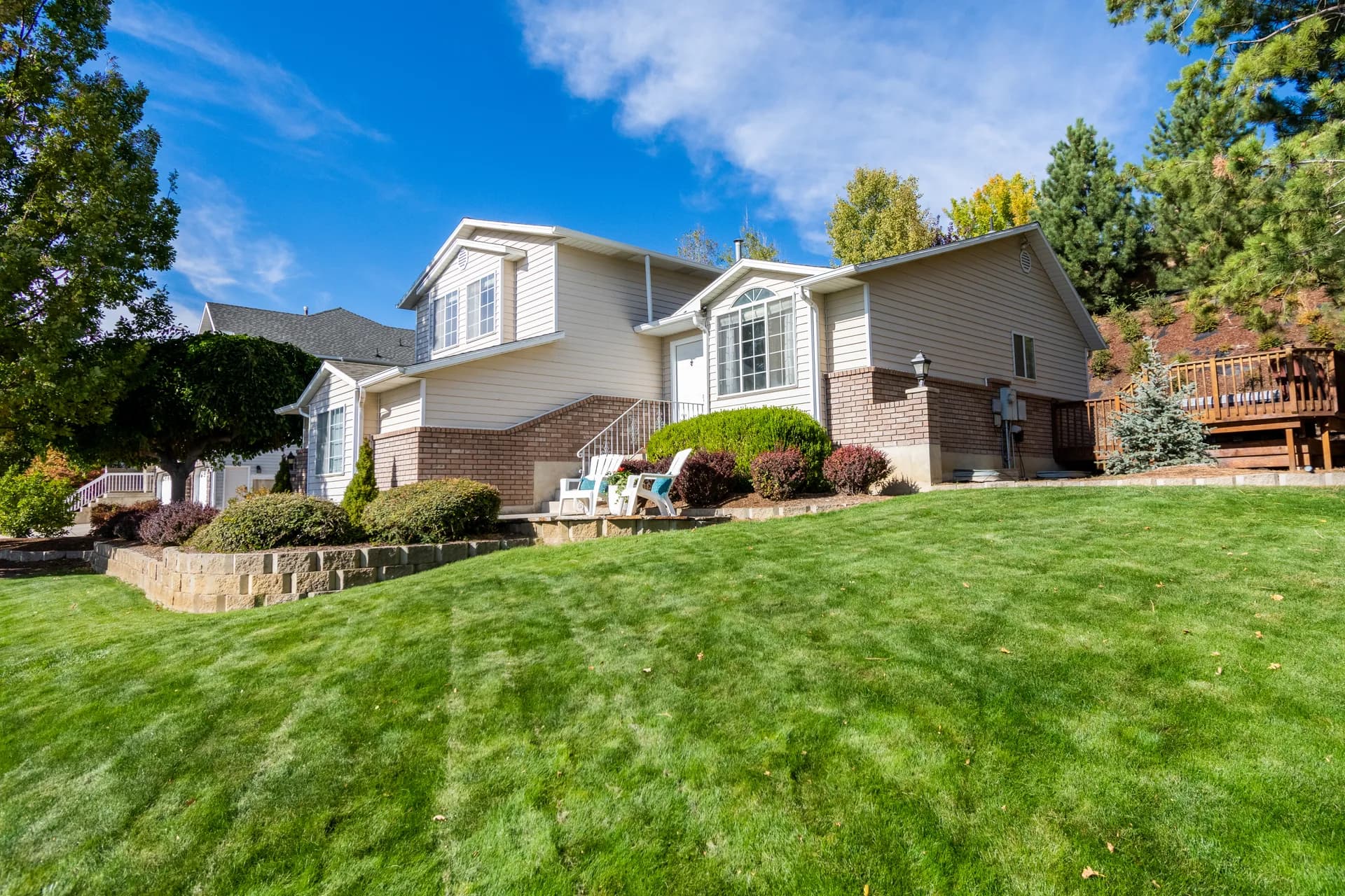 House with a green lawn under blue sky